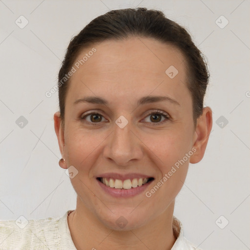 Joyful white adult female with short  brown hair and brown eyes