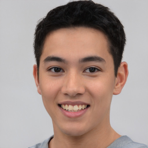 Joyful white young-adult male with short  black hair and brown eyes