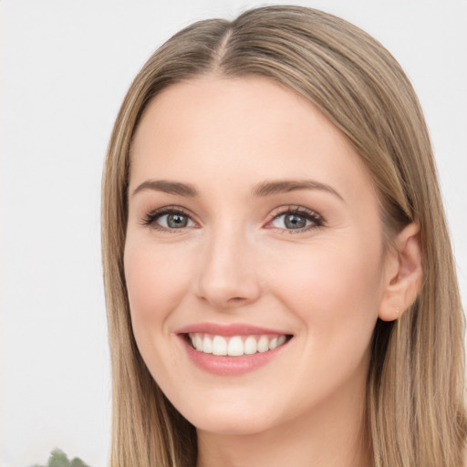 Joyful white young-adult female with long  brown hair and green eyes