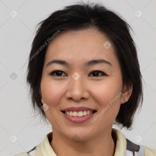 Joyful asian adult female with medium  brown hair and brown eyes