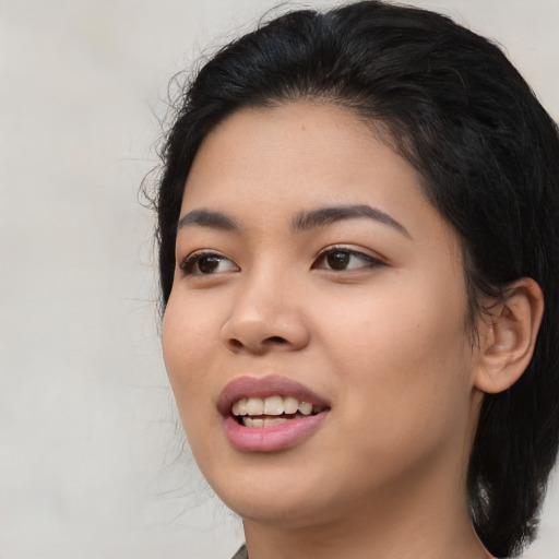 Joyful asian young-adult female with long  black hair and brown eyes