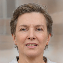 Joyful white adult female with medium  brown hair and grey eyes