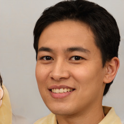 Joyful white young-adult male with medium  brown hair and brown eyes