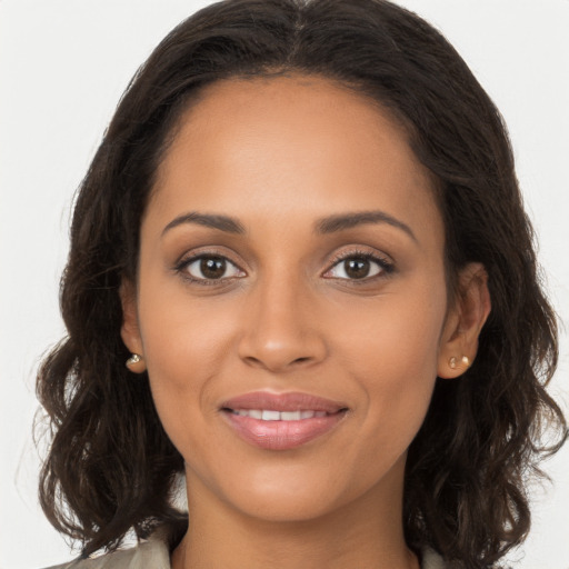 Joyful black young-adult female with long  brown hair and brown eyes