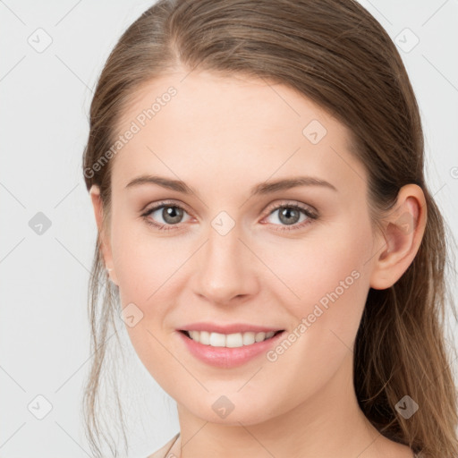 Joyful white young-adult female with long  brown hair and grey eyes