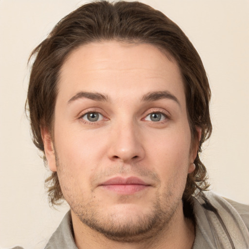 Joyful white young-adult male with short  brown hair and grey eyes