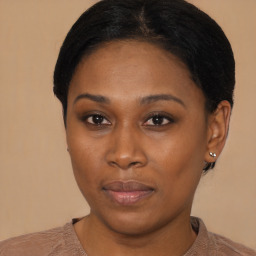 Joyful black young-adult female with short  black hair and brown eyes