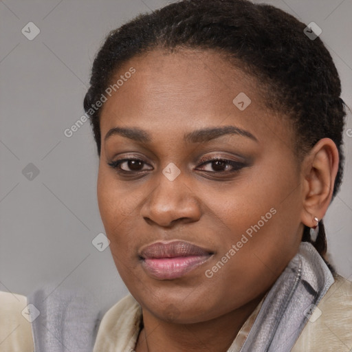 Joyful black young-adult female with short  brown hair and brown eyes