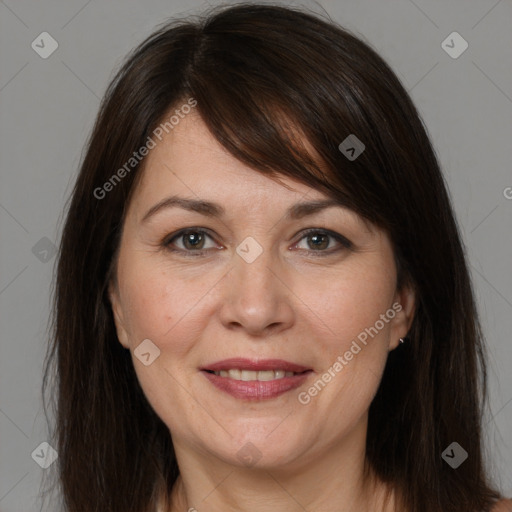 Joyful white adult female with medium  brown hair and brown eyes