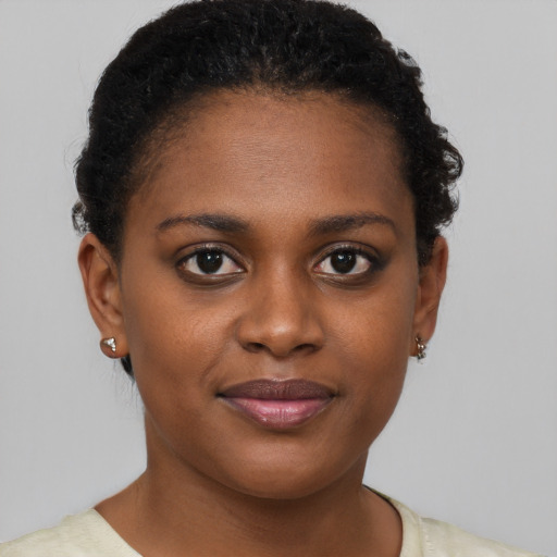 Joyful black young-adult female with short  brown hair and brown eyes