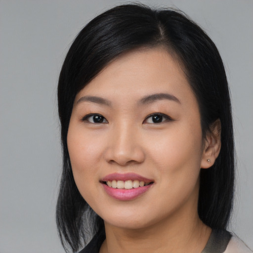 Joyful asian young-adult female with medium  black hair and brown eyes