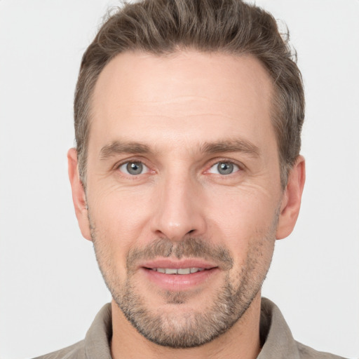 Joyful white adult male with short  brown hair and brown eyes