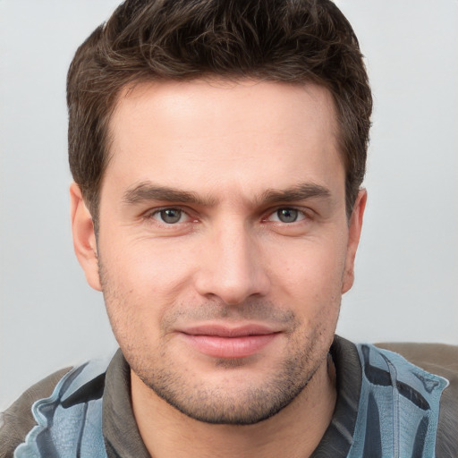 Joyful white young-adult male with short  brown hair and brown eyes