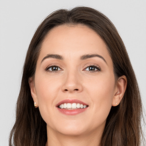 Joyful white young-adult female with long  brown hair and brown eyes