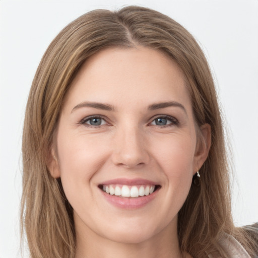 Joyful white young-adult female with long  brown hair and grey eyes