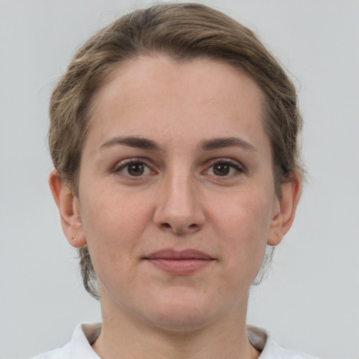 Joyful white adult female with short  brown hair and grey eyes