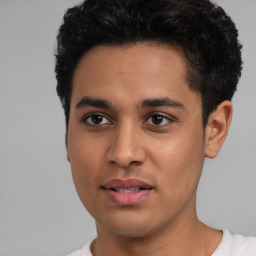 Joyful latino young-adult male with short  black hair and brown eyes