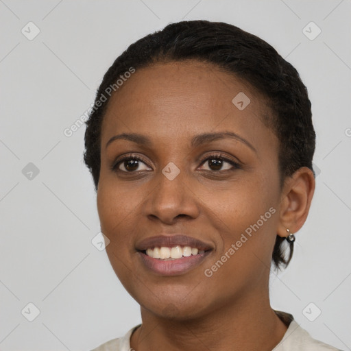 Joyful black young-adult female with short  black hair and brown eyes