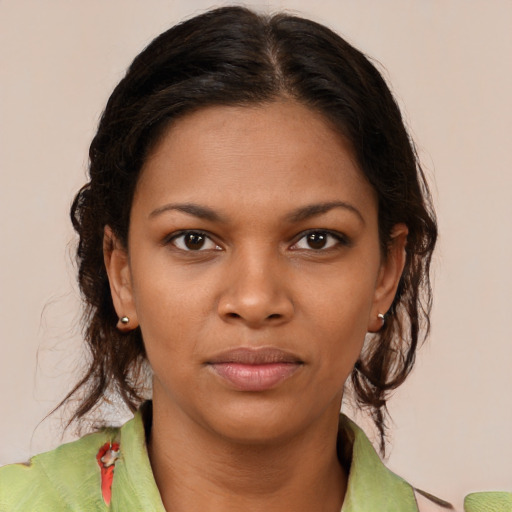 Joyful black young-adult female with medium  brown hair and brown eyes