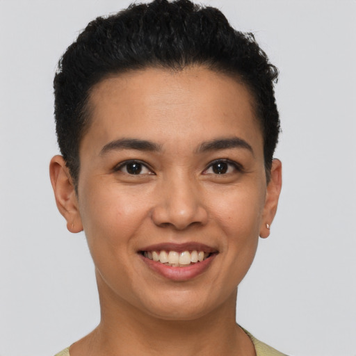 Joyful latino young-adult male with short  brown hair and brown eyes