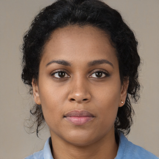 Neutral black young-adult female with medium  brown hair and brown eyes