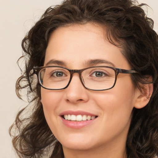 Joyful white young-adult female with medium  brown hair and green eyes