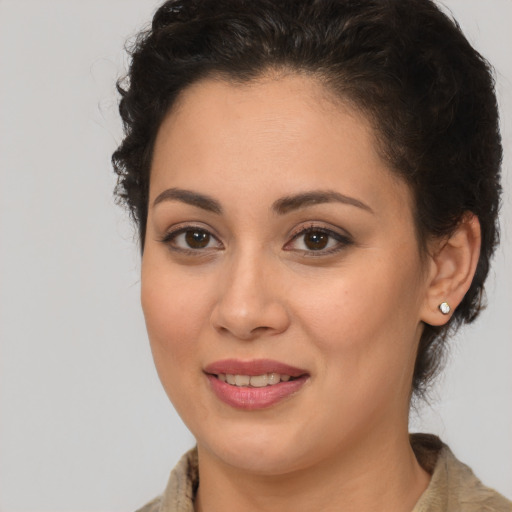 Joyful latino young-adult female with medium  brown hair and brown eyes