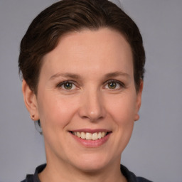 Joyful white adult female with short  brown hair and grey eyes