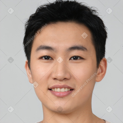 Joyful asian young-adult male with short  black hair and brown eyes