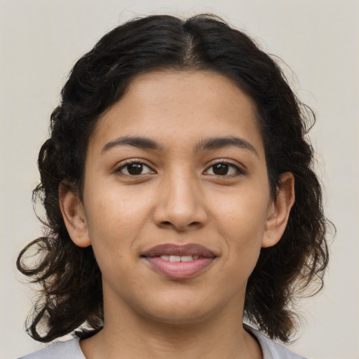 Joyful latino young-adult female with medium  brown hair and brown eyes