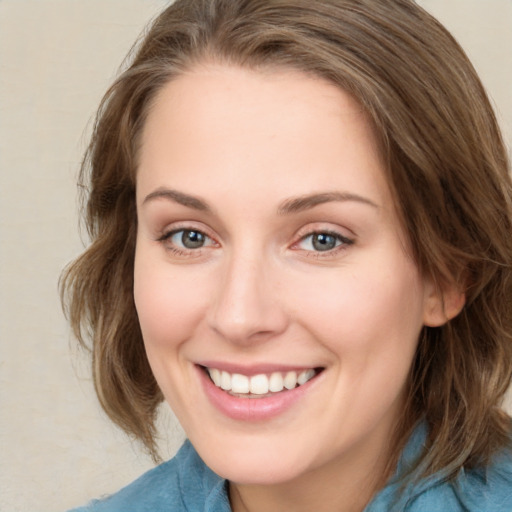 Joyful white young-adult female with medium  brown hair and blue eyes