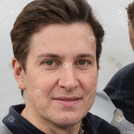 Joyful white adult male with short  brown hair and grey eyes