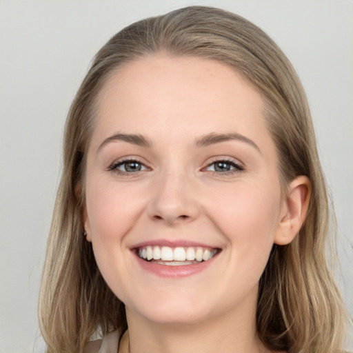 Joyful white young-adult female with long  brown hair and grey eyes