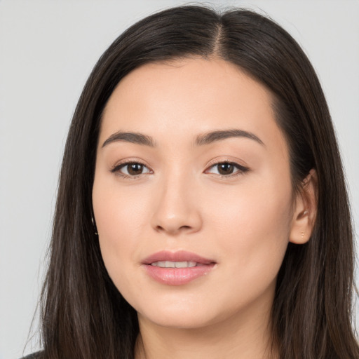 Joyful white young-adult female with long  black hair and brown eyes