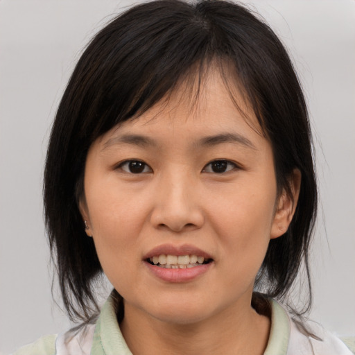 Joyful asian young-adult female with medium  brown hair and brown eyes