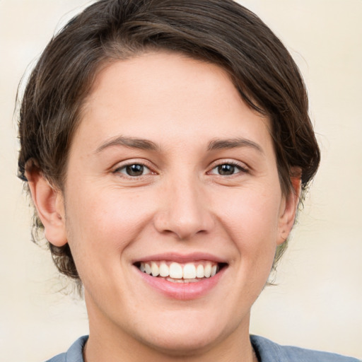 Joyful white young-adult female with medium  brown hair and brown eyes