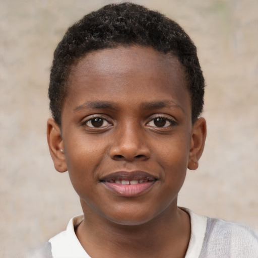 Joyful black child male with short  brown hair and brown eyes