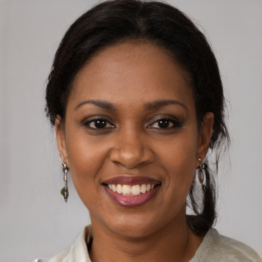 Joyful black young-adult female with medium  brown hair and brown eyes