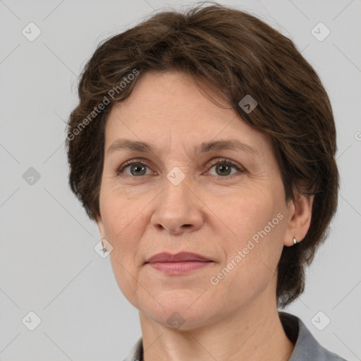 Joyful white adult female with medium  brown hair and grey eyes