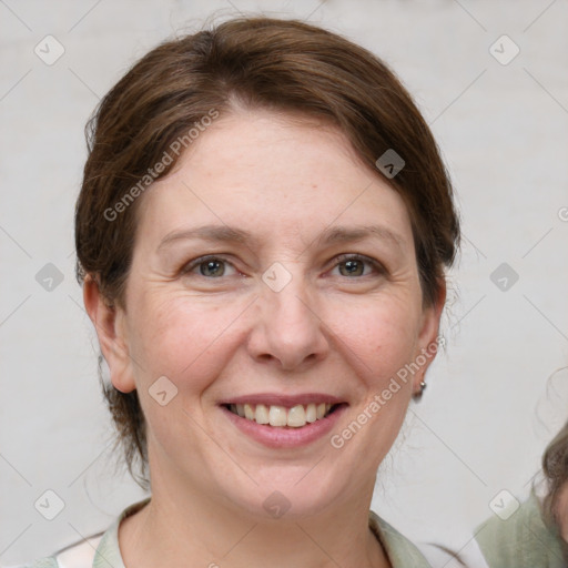 Joyful white adult female with medium  brown hair and grey eyes