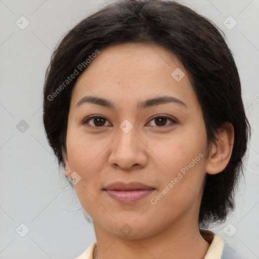 Joyful latino young-adult female with medium  brown hair and brown eyes