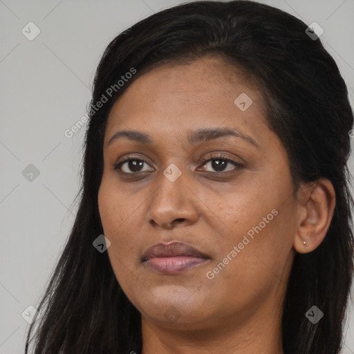 Joyful black young-adult female with long  brown hair and brown eyes