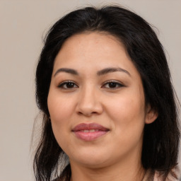 Joyful latino young-adult female with medium  brown hair and brown eyes