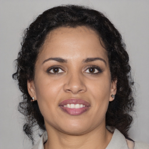 Joyful black young-adult female with medium  brown hair and brown eyes