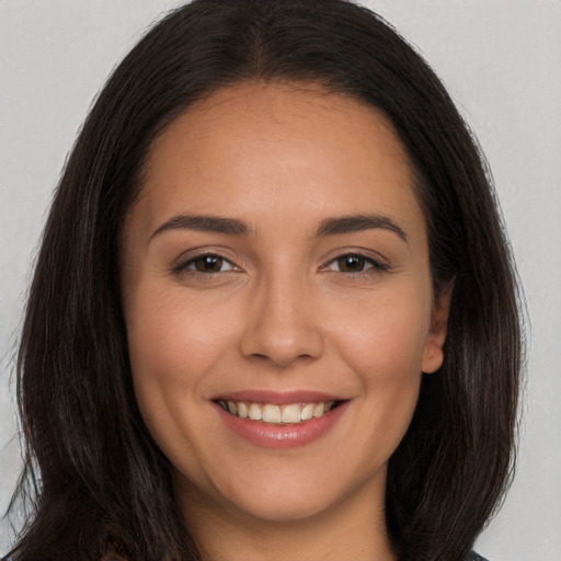 Joyful white young-adult female with long  brown hair and brown eyes