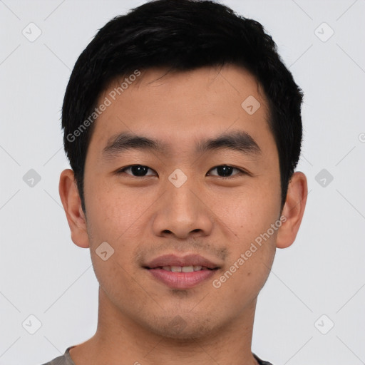 Joyful asian young-adult male with short  black hair and brown eyes