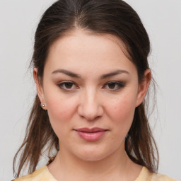 Joyful white young-adult female with medium  brown hair and brown eyes