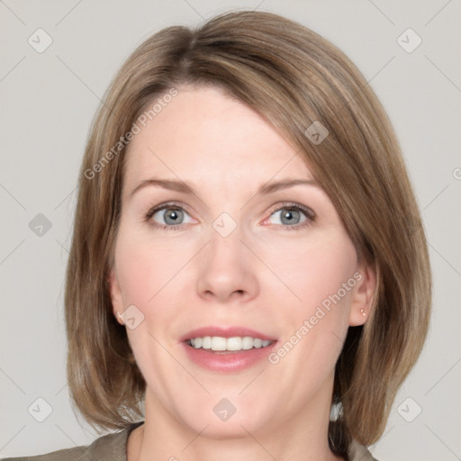 Joyful white adult female with medium  brown hair and grey eyes