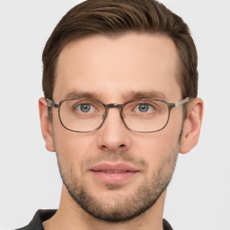 Joyful white young-adult male with short  brown hair and grey eyes