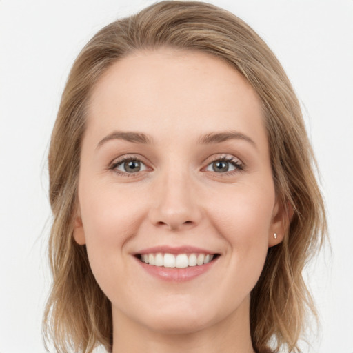 Joyful white young-adult female with long  brown hair and blue eyes